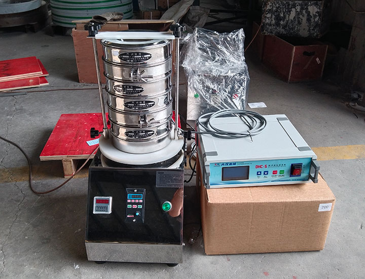 Laboratory ultrasonic vibrating sieve setup for testing difficult-to-screen powders and verifying particle-size fractions.